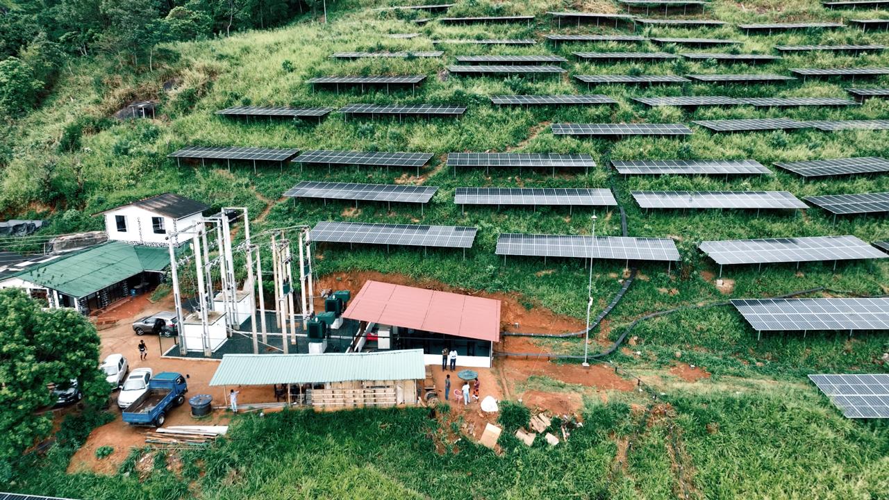 Close-up of solar panels on a green hillside